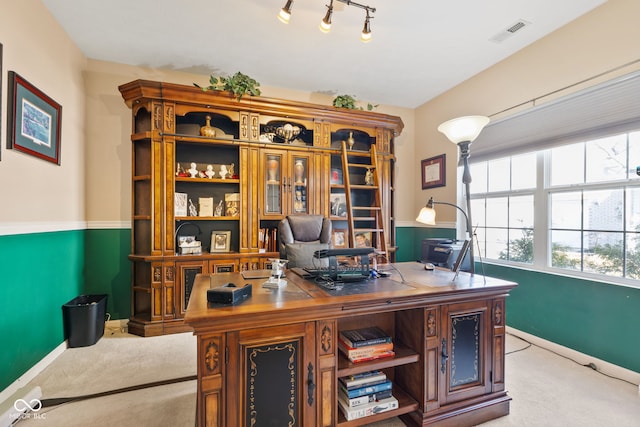 carpeted office space with track lighting, visible vents, and baseboards