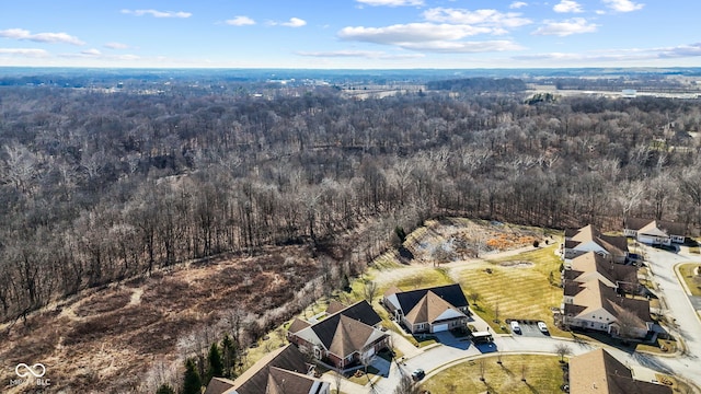 birds eye view of property with a view of trees