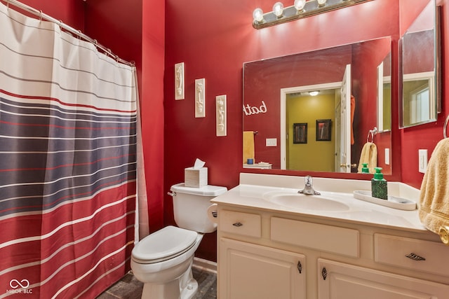 bathroom featuring toilet, a shower with shower curtain, and vanity