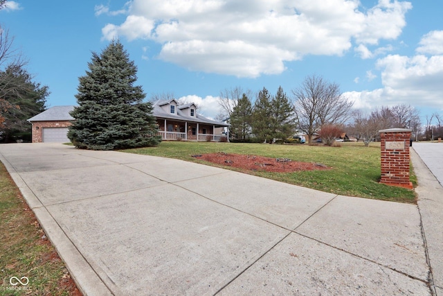 view of front facade with driveway, a front lawn, a porch, and brick siding