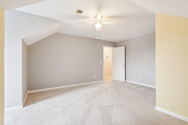 interior space featuring vaulted ceiling, visible vents, ceiling fan, and baseboards