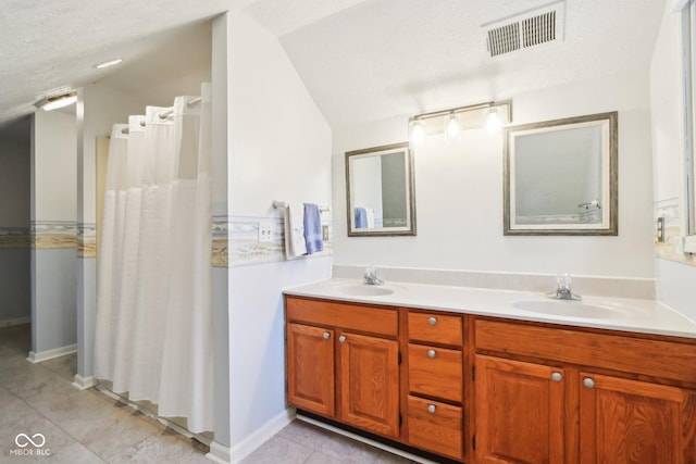 full bathroom featuring vaulted ceiling, double vanity, a sink, and visible vents