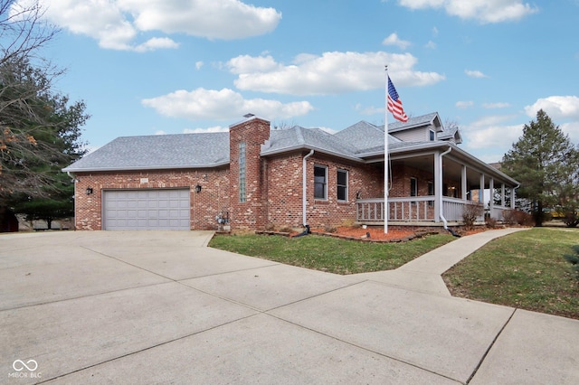 view of front of home with covered porch, a garage, brick siding, driveway, and a chimney