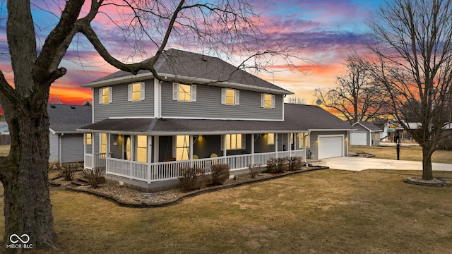 view of front of house with an attached garage, covered porch, a shingled roof, driveway, and a front yard