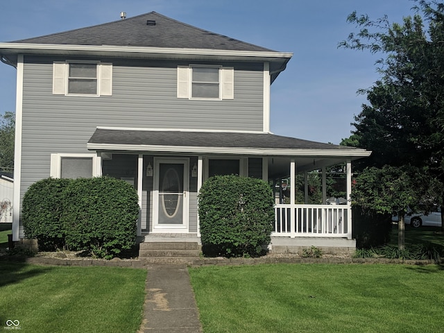 view of front facade featuring a front lawn, a porch, and roof with shingles