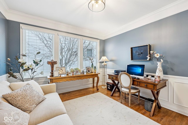 office space featuring a wealth of natural light, a wainscoted wall, visible vents, and wood finished floors