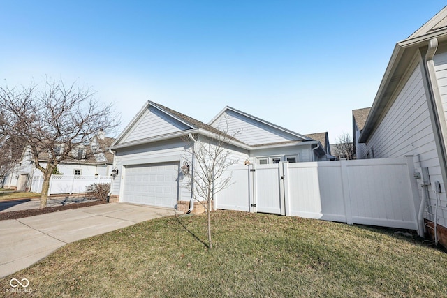 view of home's exterior featuring a gate, fence, a yard, concrete driveway, and a garage