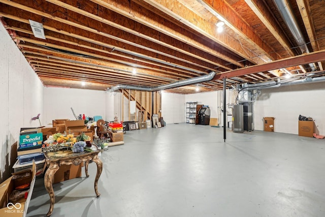 unfinished basement featuring gas water heater