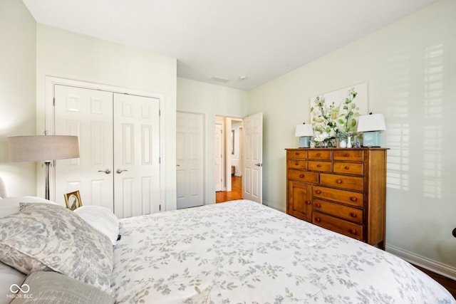 bedroom featuring baseboards and a closet