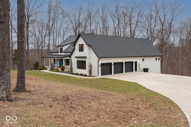 modern farmhouse with an attached garage, a shingled roof, driveway, a front lawn, and board and batten siding