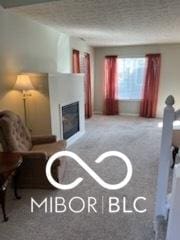 carpeted living room with a fireplace and a textured ceiling