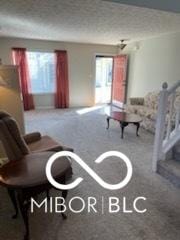 living room with stairway, carpet flooring, and a textured ceiling