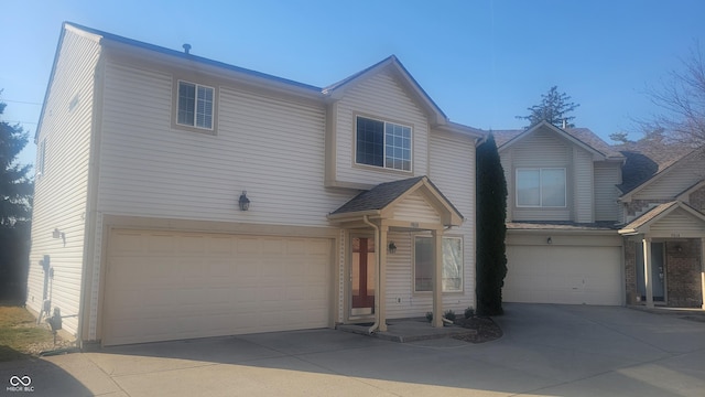 traditional-style house featuring an attached garage and driveway