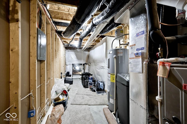 unfinished below grade area featuring electric panel and water heater