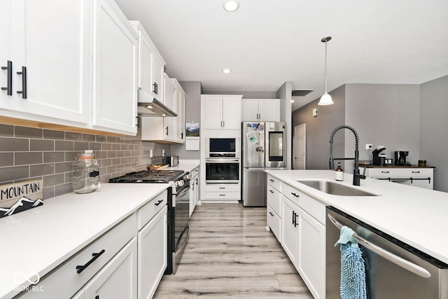 kitchen with white cabinets, a sink, stainless steel appliances, under cabinet range hood, and backsplash