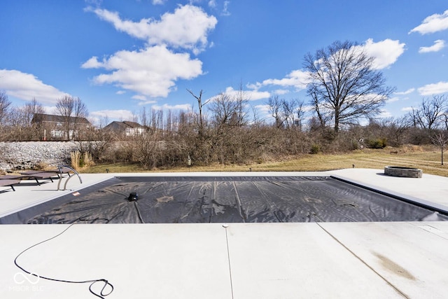 view of swimming pool with a fire pit