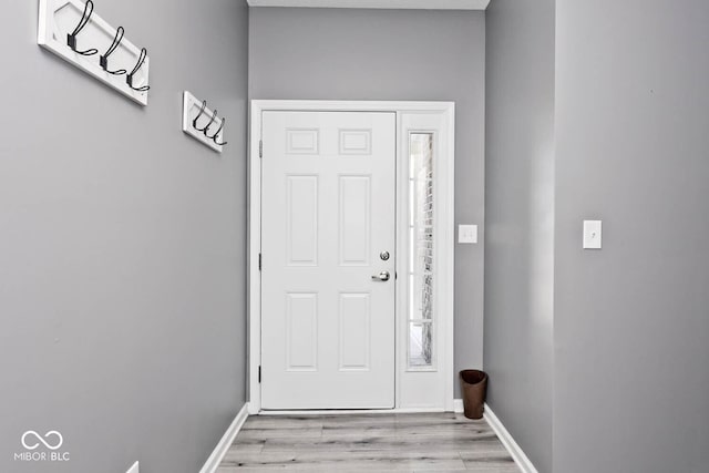 entryway featuring baseboards and light wood-style floors