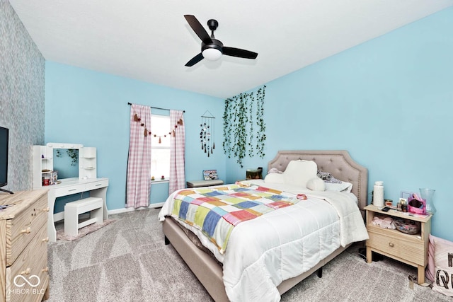 carpeted bedroom featuring ceiling fan and baseboards