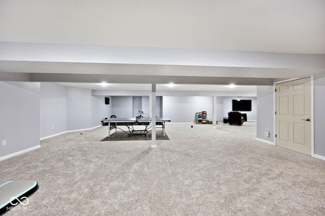 exercise area featuring carpet and baseboards