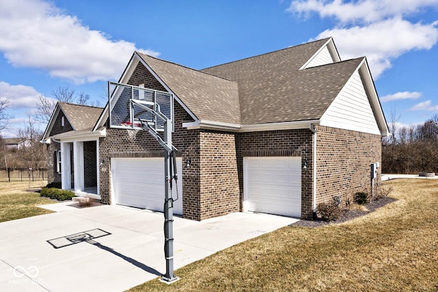 view of front facade with driveway, brick siding, a front yard, and a shingled roof