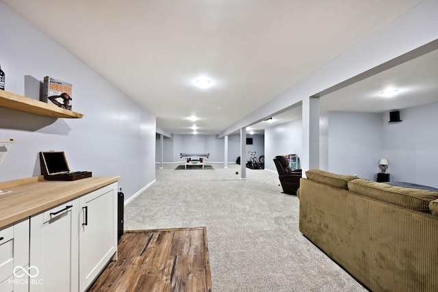 interior space with dark colored carpet and baseboards