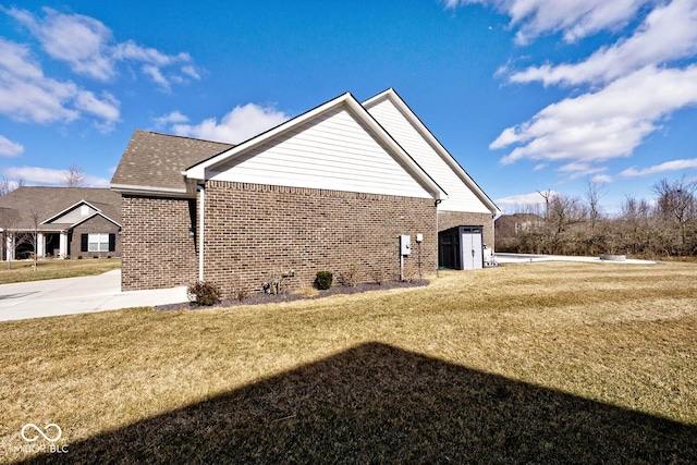 view of property exterior with brick siding and a lawn