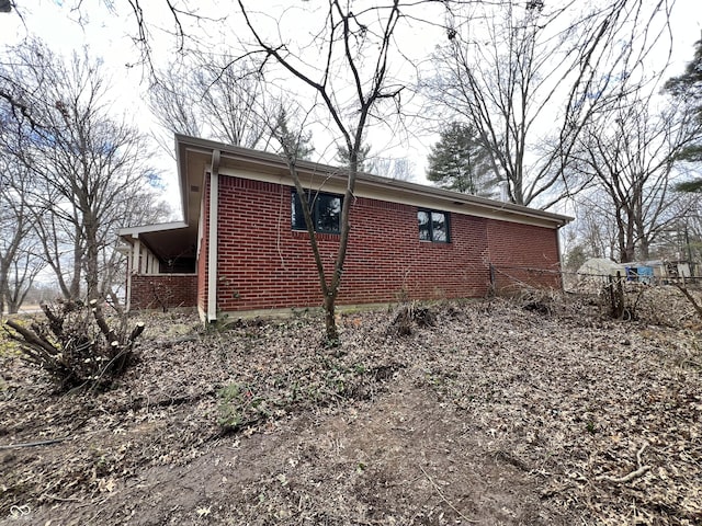 view of side of home with brick siding