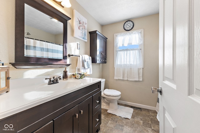 full bathroom with toilet, visible vents, baseboards, and vanity