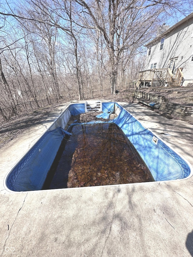 view of swimming pool featuring a wooden deck