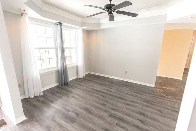 empty room featuring baseboards, dark wood-style flooring, and crown molding