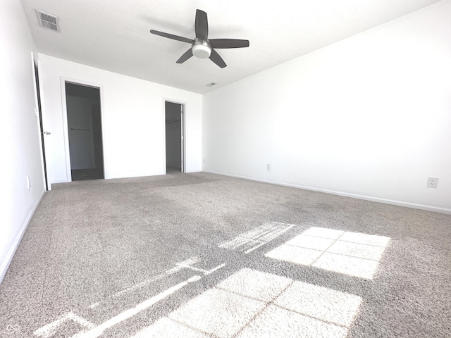 unfurnished bedroom featuring a ceiling fan, carpet, visible vents, and baseboards