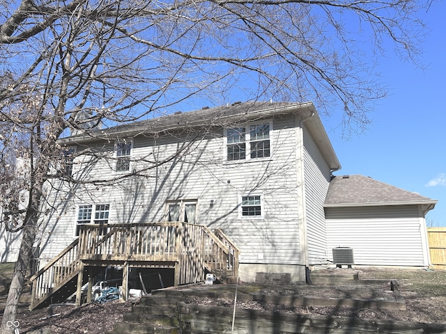 back of house featuring roof with shingles, stairs, central AC unit, and a wooden deck