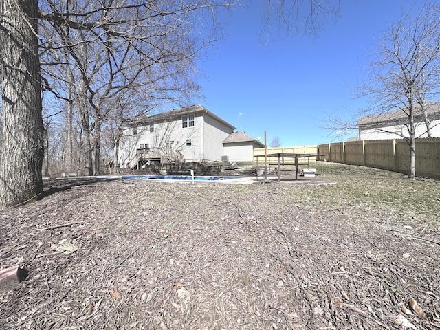 rear view of property with a fenced backyard and a fenced in pool