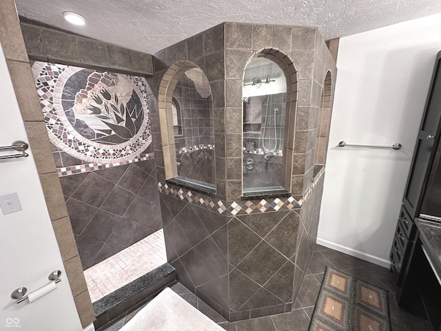 full bathroom with tile patterned flooring, baseboards, walk in shower, and a textured ceiling