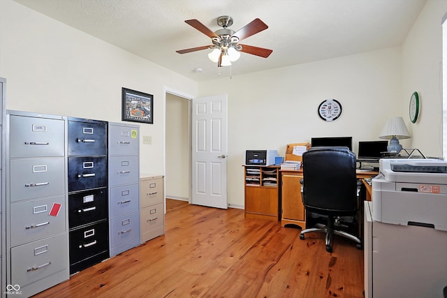 home office featuring a ceiling fan and light wood finished floors