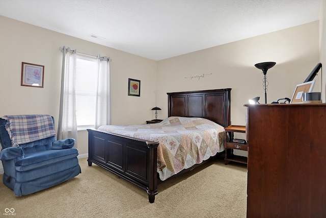 bedroom with visible vents and light colored carpet