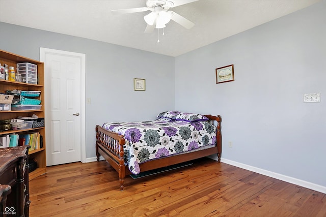 bedroom featuring a ceiling fan, baseboards, and light wood finished floors