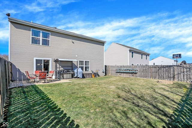 rear view of property with a patio, a lawn, and a fenced backyard