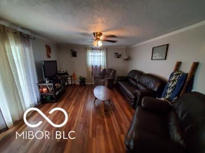 living area featuring ornamental molding, a ceiling fan, and wood finished floors