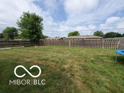 view of yard with a trampoline and a fenced backyard