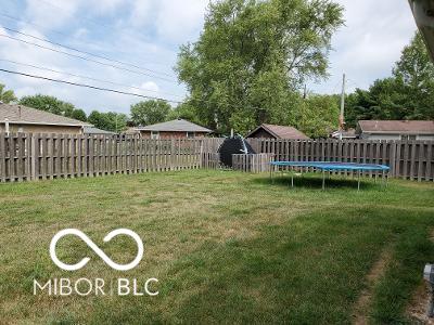 view of yard with a trampoline and a fenced backyard