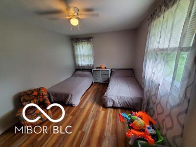 bedroom with ceiling fan and wood finished floors