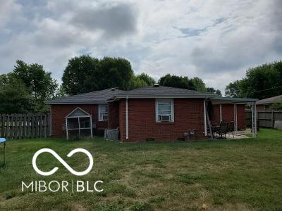 back of property featuring a yard, brick siding, and fence