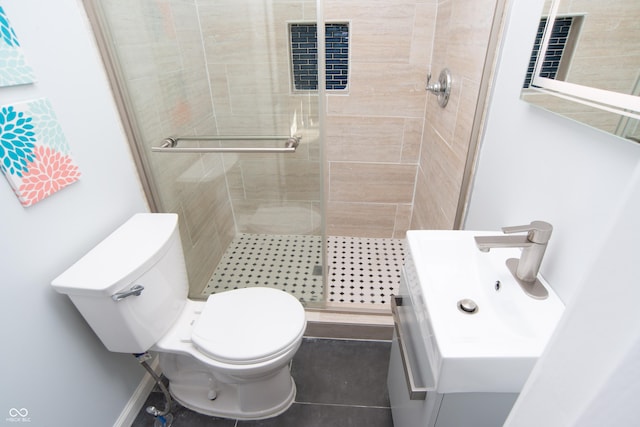 bathroom featuring a shower stall, toilet, and vanity