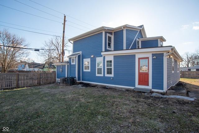 back of house with fence and a yard