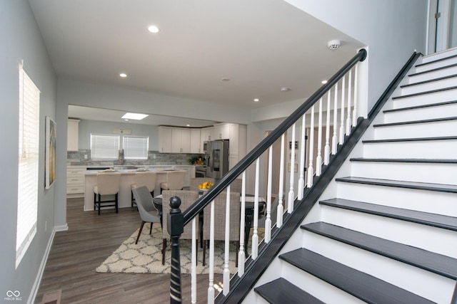 stairs featuring recessed lighting, baseboards, and wood finished floors