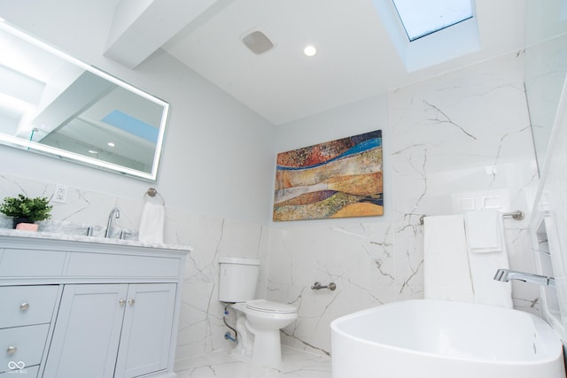 full bath featuring marble finish floor, recessed lighting, a soaking tub, toilet, and vanity