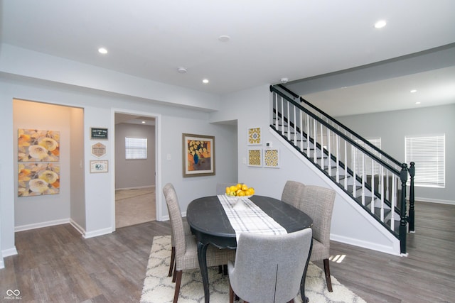 dining space featuring recessed lighting, wood finished floors, and stairs