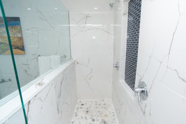 full bathroom with a marble finish shower