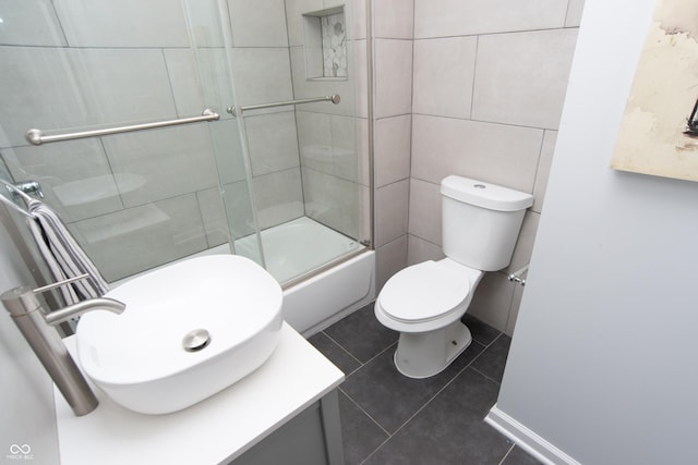 full bath featuring tile walls, vanity, toilet, and tile patterned floors